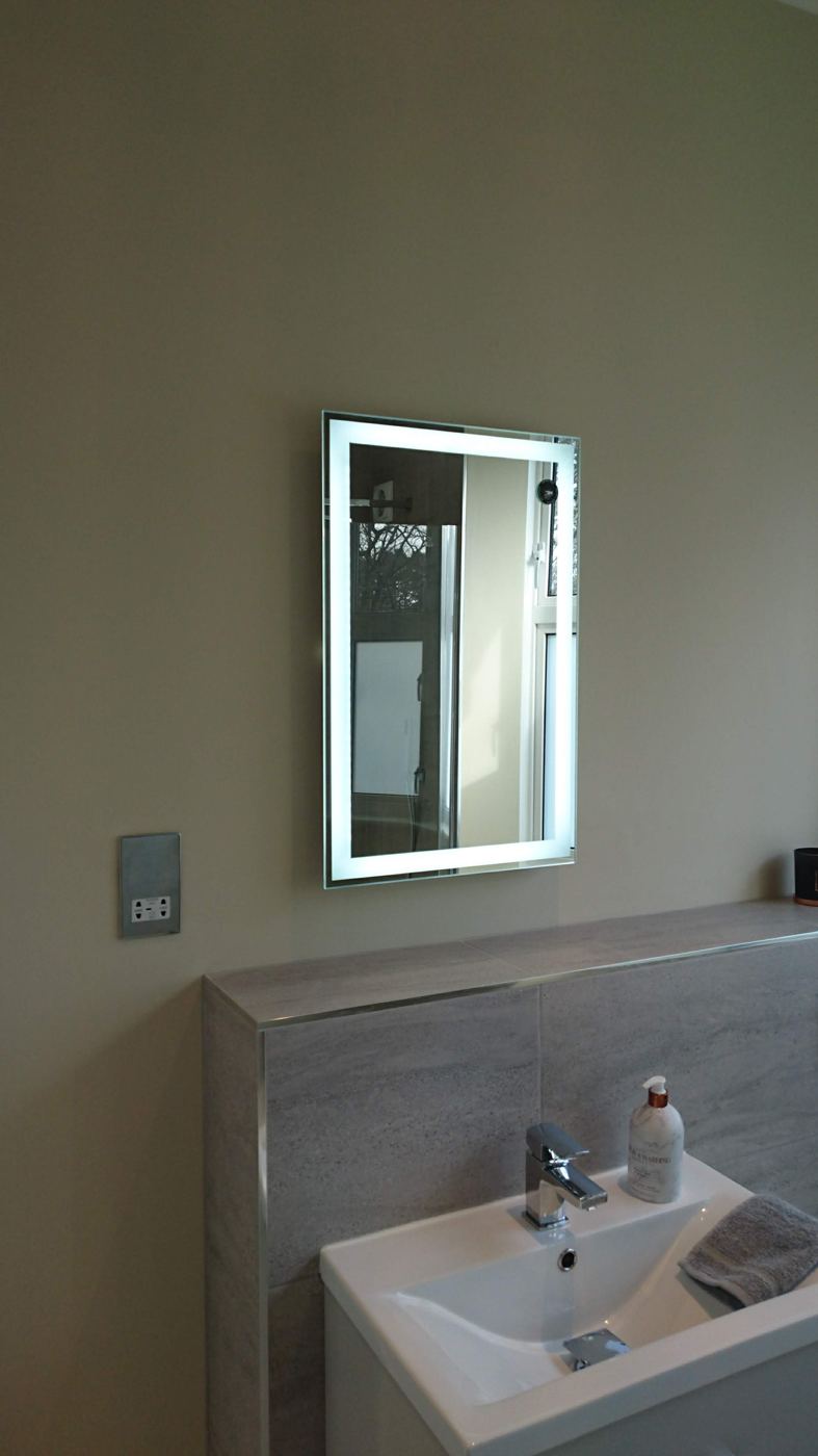 Bathroom with illuminated mirror