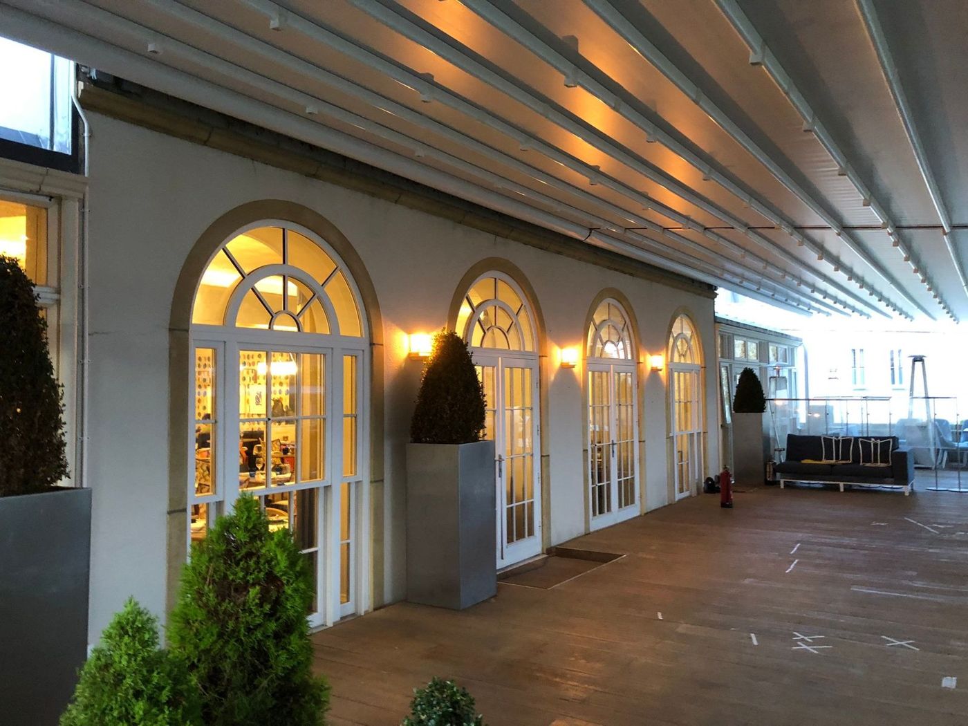 Covered terrace lit at dusk