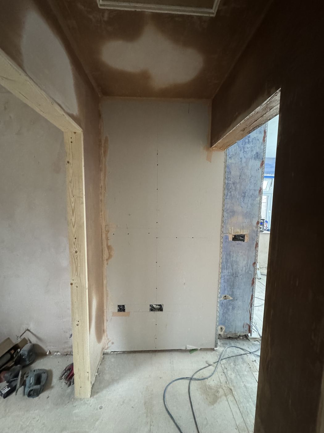 New boarded wall and timber-lined door openings