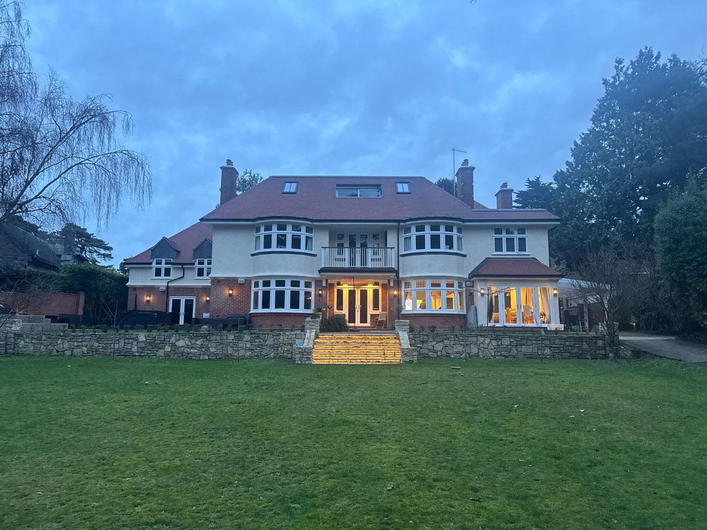 Renovated family home at dusk, seen from the garden