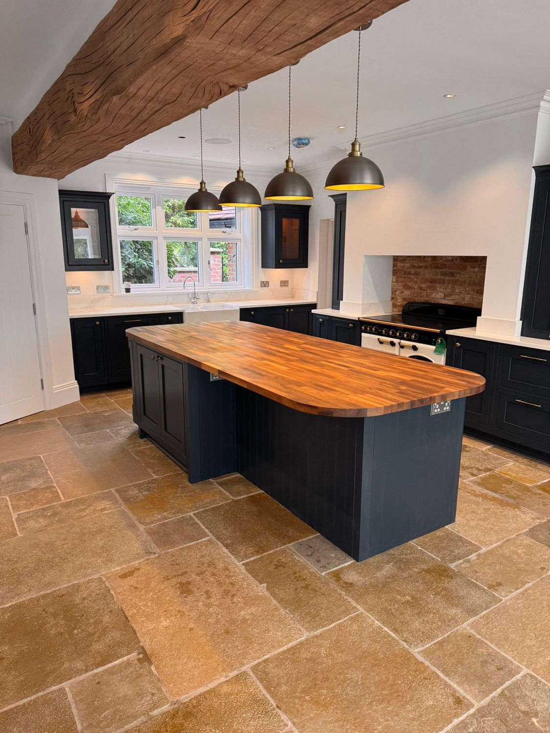 New kitchen with oak beam, island and stone floor