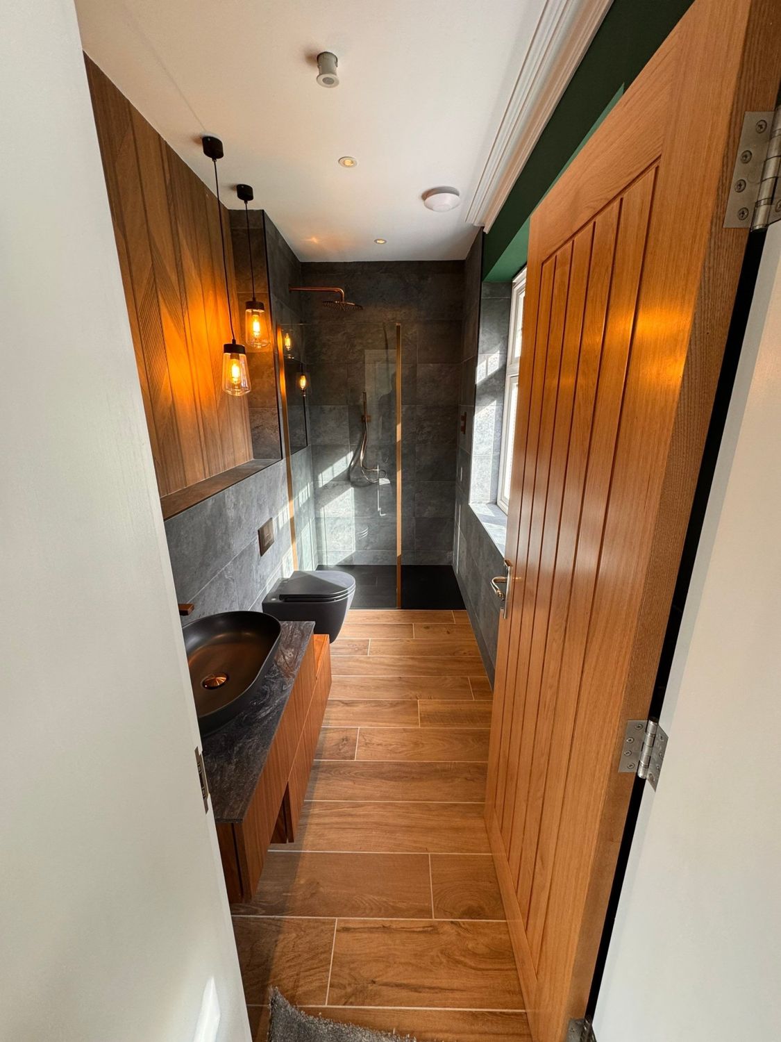 Shower room with oak panelling and copper fittings